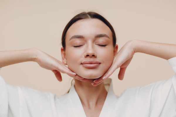Dermal Fillers Wolverhampton - woman with her eyes closed. Her head is resting on the top side of her hands.